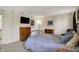 Comfortable bedroom featuring a dresser, mounted TV, and an end table at 8116 Barksdale Way, Indianapolis, IN 46216