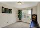 Bright bedroom featuring a window, dart board, skee ball machine, and a potted plant at 8116 Barksdale Way, Indianapolis, IN 46216