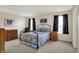 Comfortable bedroom with soft carpet, a metal bed frame, and two windows with dark curtains at 8116 Barksdale Way, Indianapolis, IN 46216