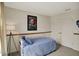 Bedroom featuring blue bedspread, window, curtains, wall decor, and a closet at 8116 Barksdale Way, Indianapolis, IN 46216