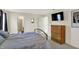 Comfortable bedroom with a view of the bathroom and features a dresser at 8116 Barksdale Way, Indianapolis, IN 46216