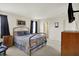 Comfortable bedroom featuring a metal bed frame, a dresser, and a mounted TV at 8116 Barksdale Way, Indianapolis, IN 46216