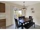 Dining area with wooden table and view through sliding doors to the fenced in yard at 8116 Barksdale Way, Indianapolis, IN 46216