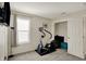Bright gym with a mounted TV and an elliptical trainer next to an open closet at 8116 Barksdale Way, Indianapolis, IN 46216