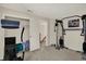 Bright gym area with exercise machines and access to the home's stairway at 8116 Barksdale Way, Indianapolis, IN 46216