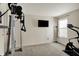Bright gym featuring a Body-Solid machine, a flat-screen TV, and an elliptical trainer at 8116 Barksdale Way, Indianapolis, IN 46216