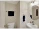 Compact half bathroom with modern fixtures, a stylish mirror, and space-saving design at 8116 Barksdale Way, Indianapolis, IN 46216