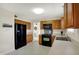 Efficient kitchen with wooden cabinets, black appliances, offering both style and functionality at 8116 Barksdale Way, Indianapolis, IN 46216