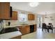 Bright kitchen with light countertops, wooden cabinets, black appliances, and adjacent dining area at 8116 Barksdale Way, Indianapolis, IN 46216