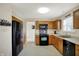 Functional kitchen with wooden cabinetry, black appliances, and ample counter space for food preparation at 8116 Barksdale Way, Indianapolis, IN 46216