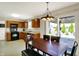Kitchen with wooden cabinets, black appliances, dining area and view of the backyard patio at 8116 Barksdale Way, Indianapolis, IN 46216