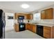 Well-lit kitchen with wooden cabinets, modern appliances, and a convenient layout at 8116 Barksdale Way, Indianapolis, IN 46216