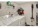Practical laundry room with washer, dryer, storage shelves, and cleaning equipment at 8116 Barksdale Way, Indianapolis, IN 46216