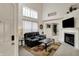 Bright and airy living room with vaulted ceilings, fireplace, and a black leather couch for relaxing at 8116 Barksdale Way, Indianapolis, IN 46216