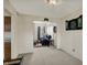 Spacious living room with comfortable seating, a dartboard, and an adjacent kitchen area at 8116 Barksdale Way, Indianapolis, IN 46216