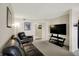 Living room featuring a leather sofa, mounted television, and neutral carpeting at 8116 Barksdale Way, Indianapolis, IN 46216