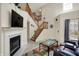 Comfortable living room with a fireplace, vaulted ceilings, and a cozy leather couch for relaxation at 8116 Barksdale Way, Indianapolis, IN 46216