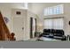 Inviting living room with vaulted ceilings, natural light, a comfy black leather couch and modern decor at 8116 Barksdale Way, Indianapolis, IN 46216