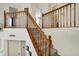 Elegant staircase with wooden banisters and neutral carpeting leading to the upper level of the home at 8116 Barksdale Way, Indianapolis, IN 46216