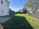 Fenced backyard featuring a well-maintained lawn, trees, and a sense of privacy at 82 Pin Oak Ct, Whiteland, IN 46184