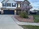 Charming two-story home featuring a well-manicured lawn, a dark garage door, and a brick and siding facade at 82 Pin Oak Ct, Whiteland, IN 46184