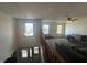 Bright living room with large windows, a comfortable gray sectional sofa, and carpeted flooring at 82 Pin Oak Ct, Whiteland, IN 46184