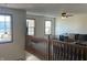 Open living room with multiple windows, a gray sectional sofa, and carpeted flooring at 82 Pin Oak Ct, Whiteland, IN 46184
