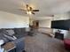 Cozy living room featuring a gray sectional, fireplace, TV, and open access to other rooms at 82 Pin Oak Ct, Whiteland, IN 46184