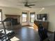 Bright living room with fireplace, ceiling fan, and large windows at 82 Pin Oak Ct, Whiteland, IN 46184