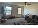 Inviting living room with windows, a comfortable gray sectional, carpet, and a ceiling fan at 82 Pin Oak Ct, Whiteland, IN 46184
