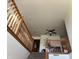 View of the staircase with wooden railings, leading to the upper level and ceiling fan at 82 Pin Oak Ct, Whiteland, IN 46184