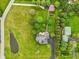 Bird's eye view featuring meticulously maintained yard, mature trees, brick walkway, pond, and lush greenery at 8362 N County Road 650 E, Brownsburg, IN 46112