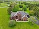 Aerial view of the brick home showcasing mature trees and lush lawn at 8362 N County Road 650 E, Brownsburg, IN 46112
