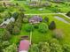 Expansive aerial view showcases lush landscaping, mature trees, brick patio and a well-maintained brick home at 8362 N County Road 650 E, Brownsburg, IN 46112
