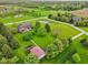 Aerial view of a home and its extensive green space, including a detached garage and a pond at 8362 N County Road 650 E, Brownsburg, IN 46112