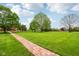 Sprawling backyard showcases a brick walkway leading to a large grassy area, perfect for outdoor enjoyment at 8362 N County Road 650 E, Brownsburg, IN 46112