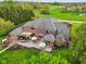 Aerial view of the backyard featuring an outdoor patio, manicured lawn, and mature trees at 8362 N County Road 650 E, Brownsburg, IN 46112