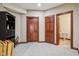 Basement with gray carpet, shelving unit, and two wooden doors leading to other areas at 8362 N County Road 650 E, Brownsburg, IN 46112
