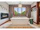 Modern bathroom featuring a freestanding tub, stone accent wall, and exterior window at 8362 N County Road 650 E, Brownsburg, IN 46112