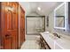 Bright bathroom featuring a modern vanity, glass shower, and elegant wood trim accents at 8362 N County Road 650 E, Brownsburg, IN 46112
