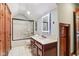 Well-lit bathroom with a modern vanity, glass-enclosed shower, and elegant wood trim at 8362 N County Road 650 E, Brownsburg, IN 46112