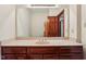 Bathroom with beige countertop, dark wood cabinets, and a large mirror reflecting the doorway at 8362 N County Road 650 E, Brownsburg, IN 46112