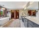 Spa-like bathroom with soaking tub, double vanity with sinks, large mirrors, and access to walk-in closets at 8362 N County Road 650 E, Brownsburg, IN 46112