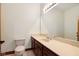 Well-lit bathroom featuring a light beige countertop, dark wood cabinets, and a large mirror at 8362 N County Road 650 E, Brownsburg, IN 46112