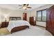 Comfortable bedroom with wood furniture, neutral carpet, ceiling fan, and natural light from the window at 8362 N County Road 650 E, Brownsburg, IN 46112