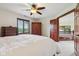 Bright bedroom with a ceiling fan, wood furniture, and an open doorway to another area at 8362 N County Road 650 E, Brownsburg, IN 46112