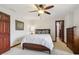 Inviting bedroom featuring wood trim, ceiling fan, and a neatly made bed for relaxation at 8362 N County Road 650 E, Brownsburg, IN 46112
