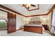 Bright main bedroom with tray ceiling, wood trim, comfortable king-size bed, and view of the property's exterior at 8362 N County Road 650 E, Brownsburg, IN 46112