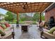 Inviting covered patio with plush seating, a fire pit, and beautiful landscaping providing a serene outdoor living space at 8362 N County Road 650 E, Brownsburg, IN 46112
