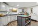 Spacious craft room with white cabinets, island, tv, wood floors, and sewing machines at 8362 N County Road 650 E, Brownsburg, IN 46112